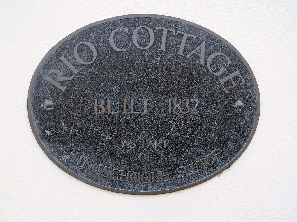Rio Cottage nameplate in Grosvenor Road, Pimlico saying it was built in 1832 for the King's Scholars Sluice