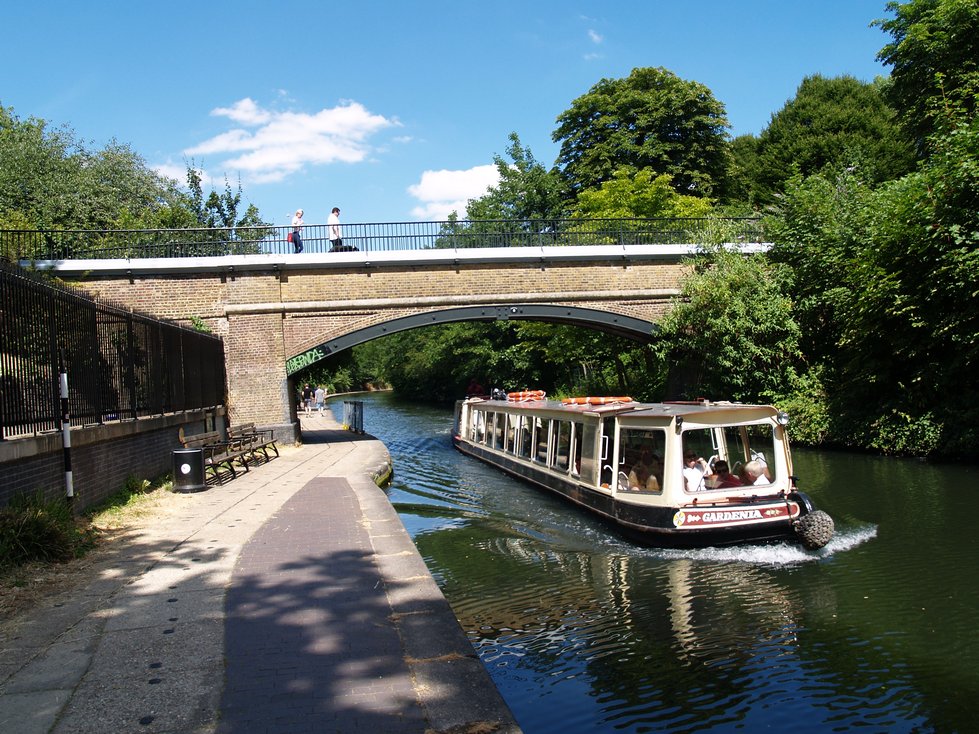 A barge on the Regents Canal passes under Charlbert Bridge 